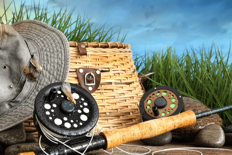 Fishing equipment with hat on wooden dock