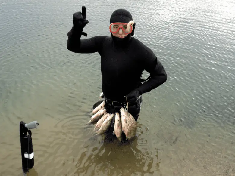 Spearfisher showing his catch