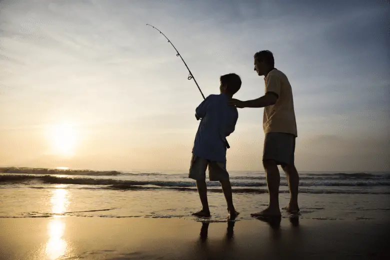 Picture of Man giving a young boy surf fishing tips