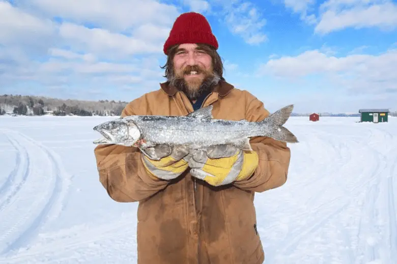 Man holding a fish in ice