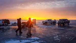 Picture of ice fishing in a winter lake