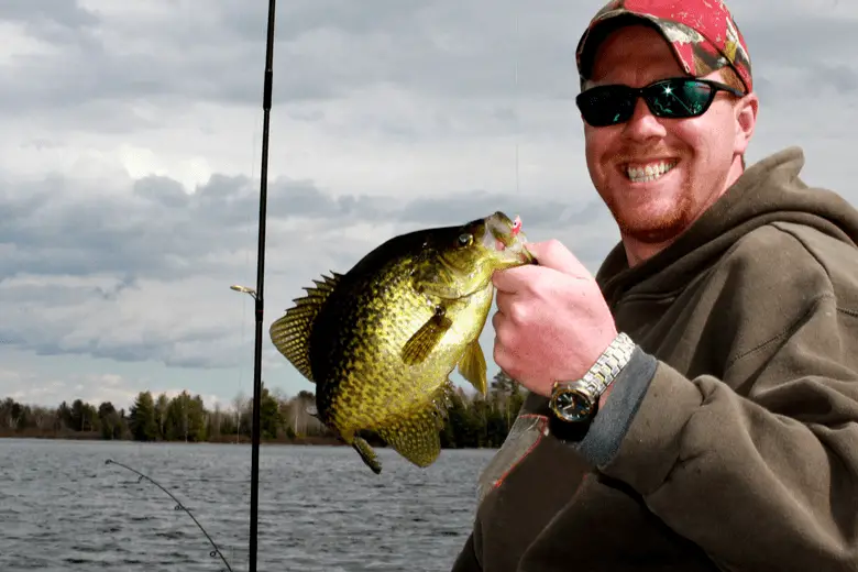 A man holding a caught crappie