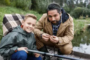 Father and son fishing with rod