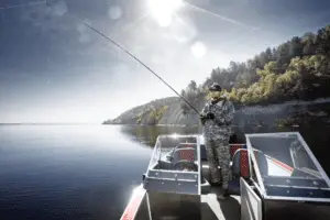 Man bass fishing from a boat