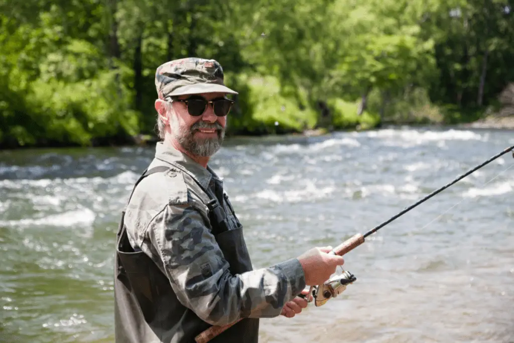 Joyful fisherman wearing sunglasses