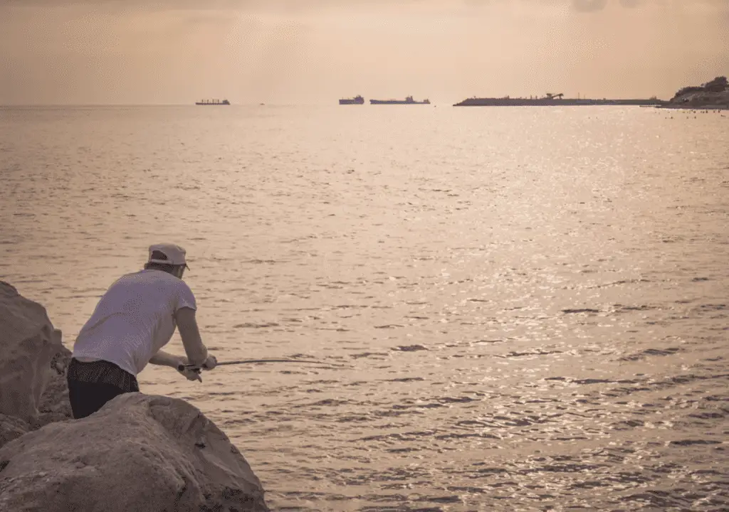 Man throwing a fishing rod into the sea