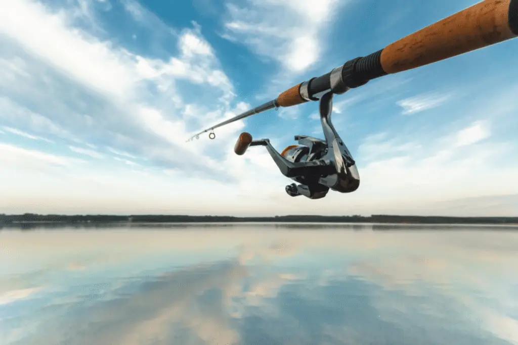 A fishing reel with a background of water