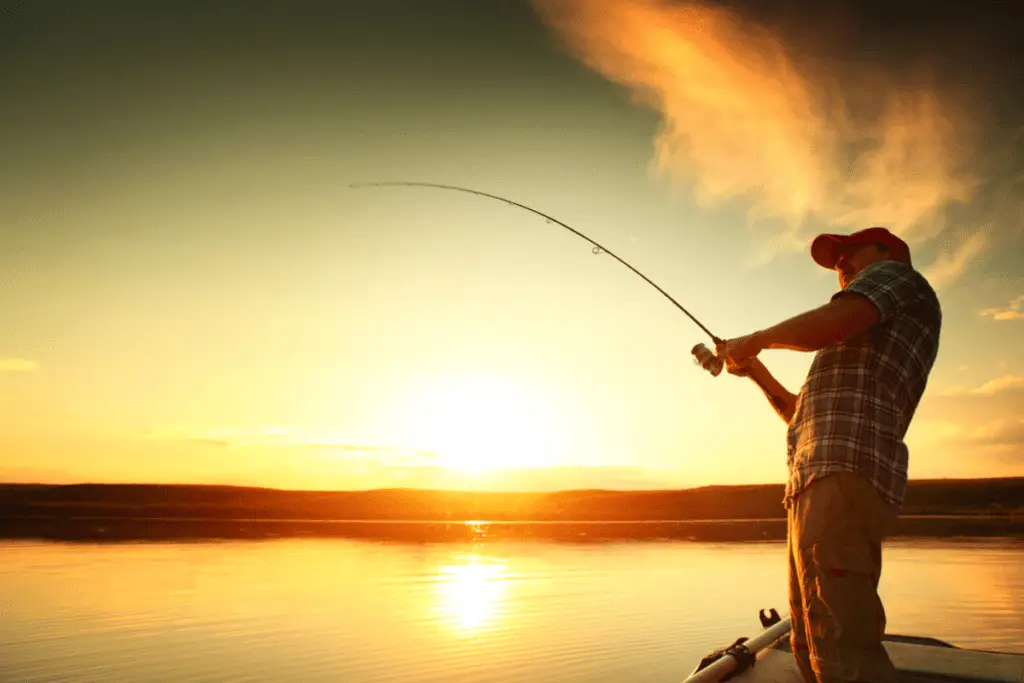 Man fishing with the sun in the background