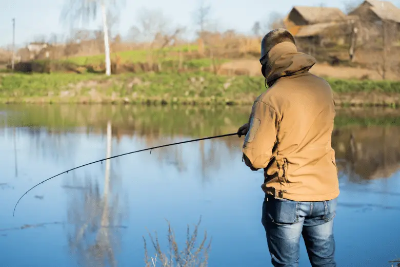 Angler casting his rod into the lake