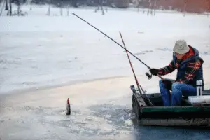 Fisherman fishing on ice