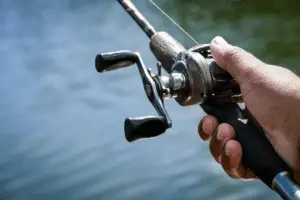 Baitcasting reel in the fisherman hand