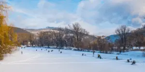 People Ice fishing on a frozen river