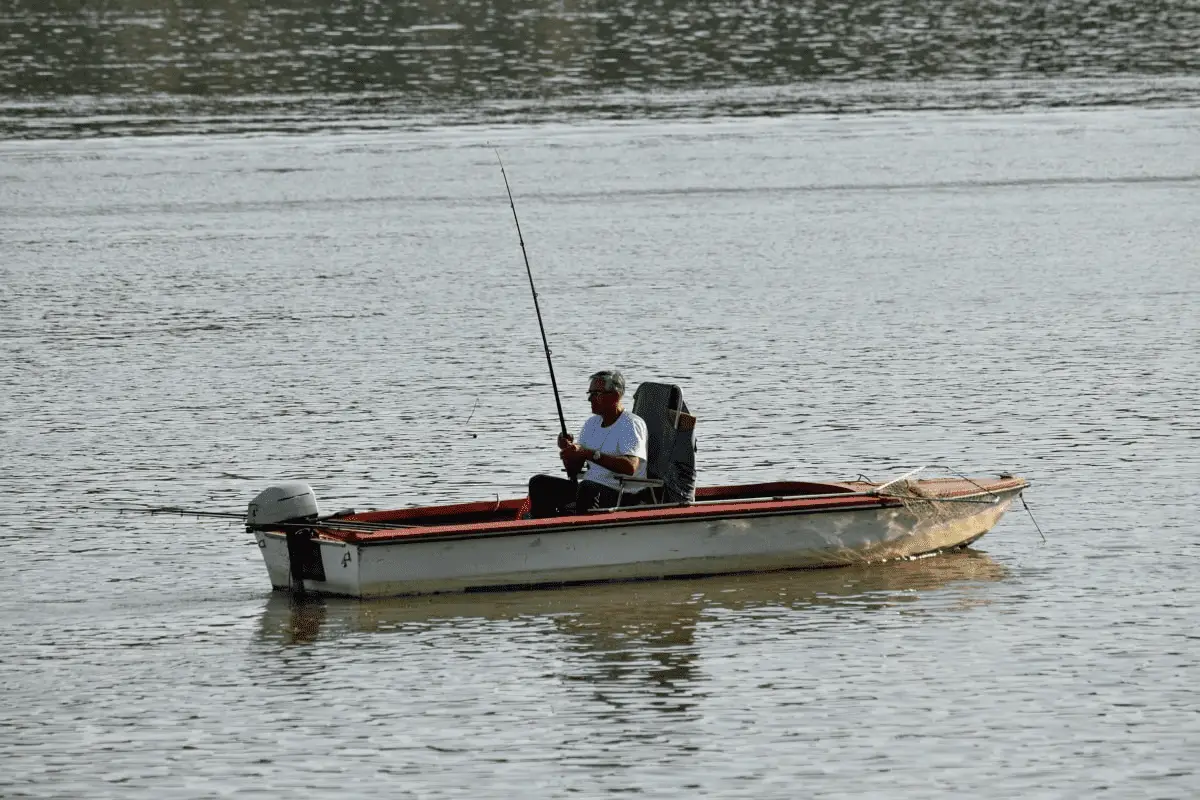 fishermen on a boat in the middle of the lake