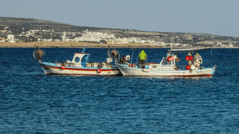 two fishing boats near the shore