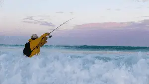 angler in yellow rain great fishing in the sea