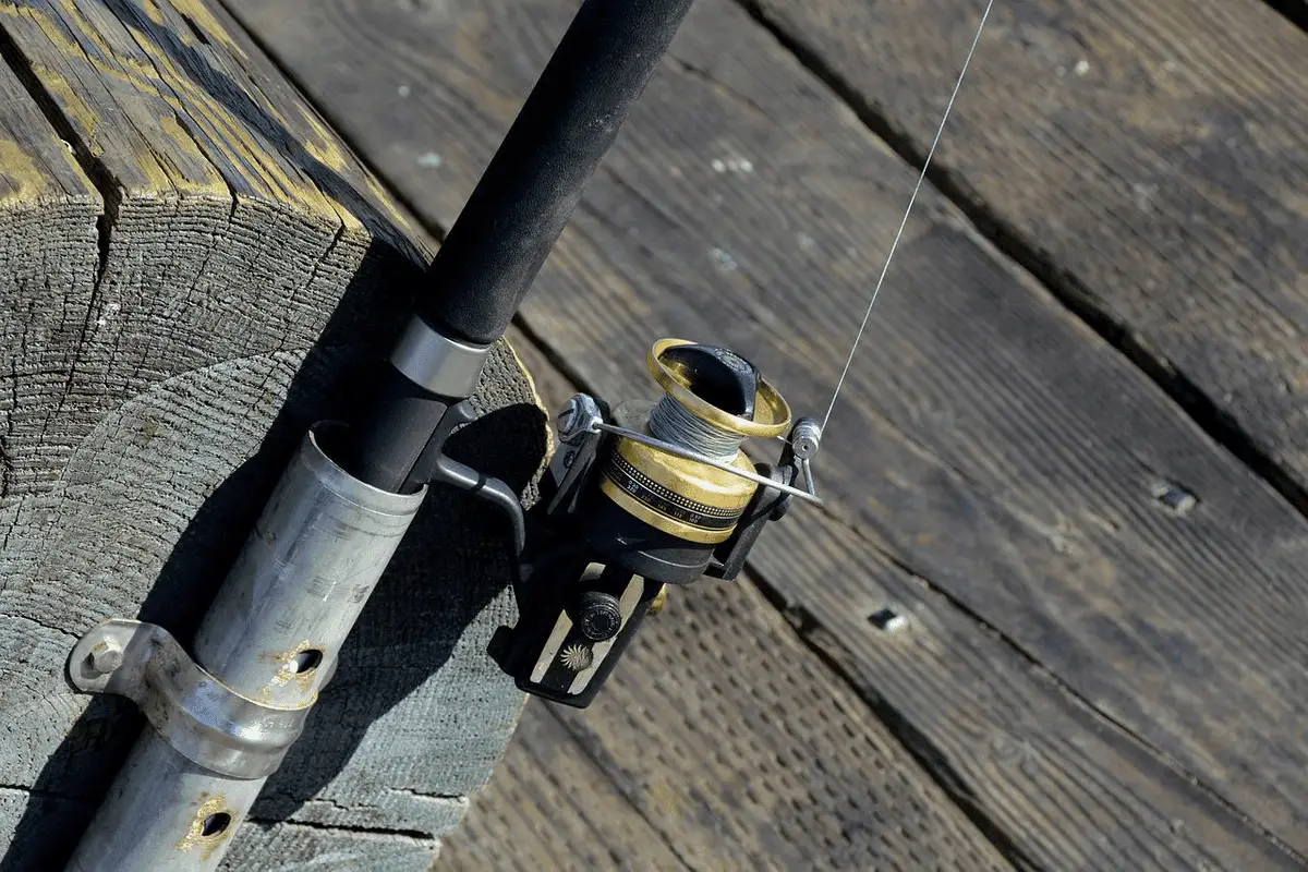 fishing rod and reel against a wooden deck