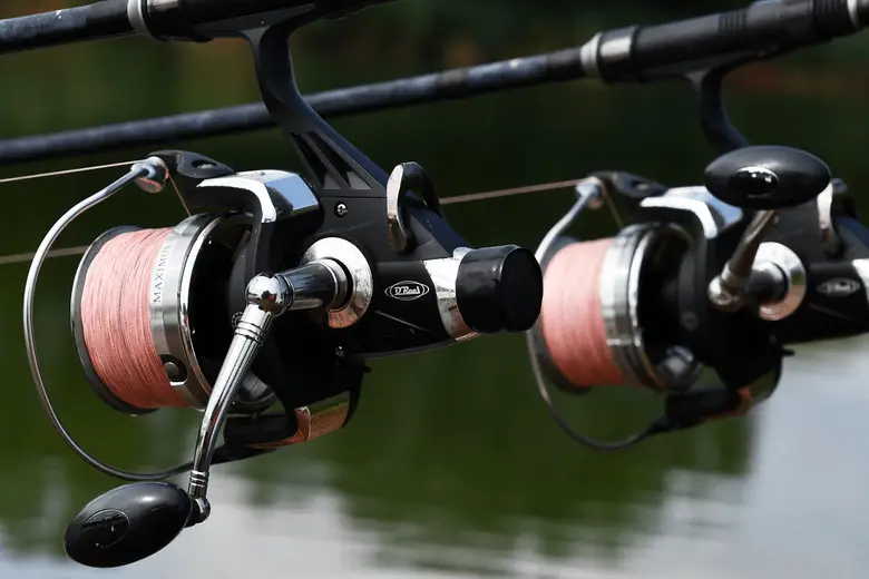 two fishing reels with a red line