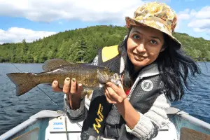 angler caught a bass from a fishing boat