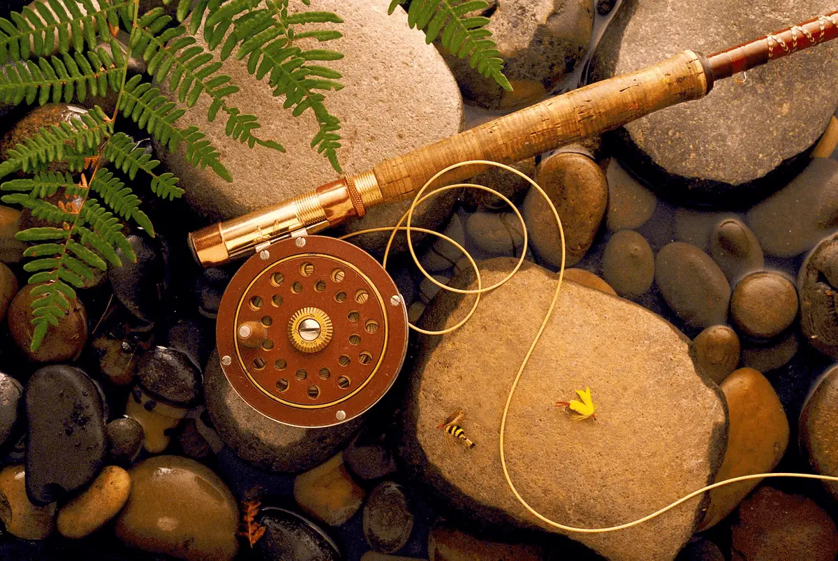 fishing rod and line over rocks in the water