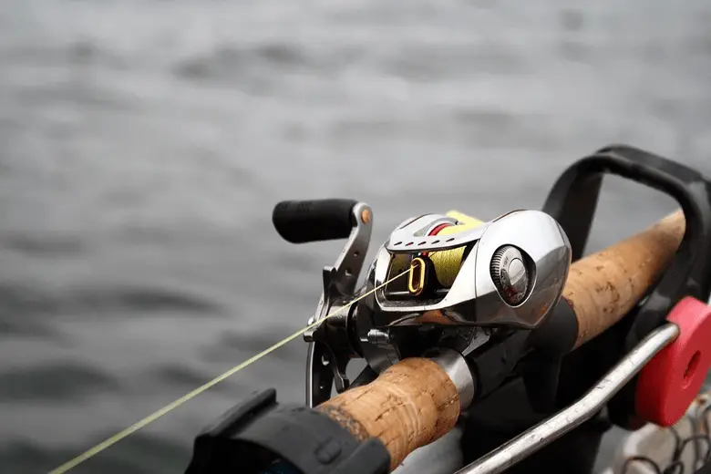 close-up shot of a fishing reel with a yellow line
