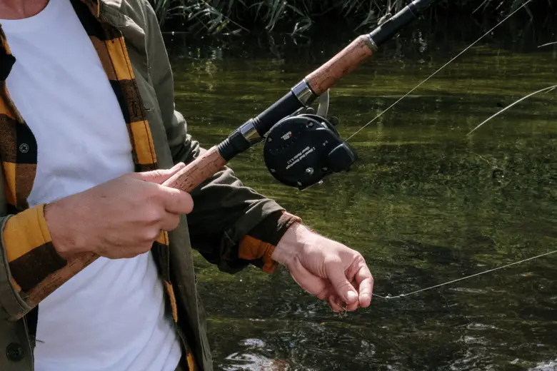 close-up shot of a man holding a fishing rod