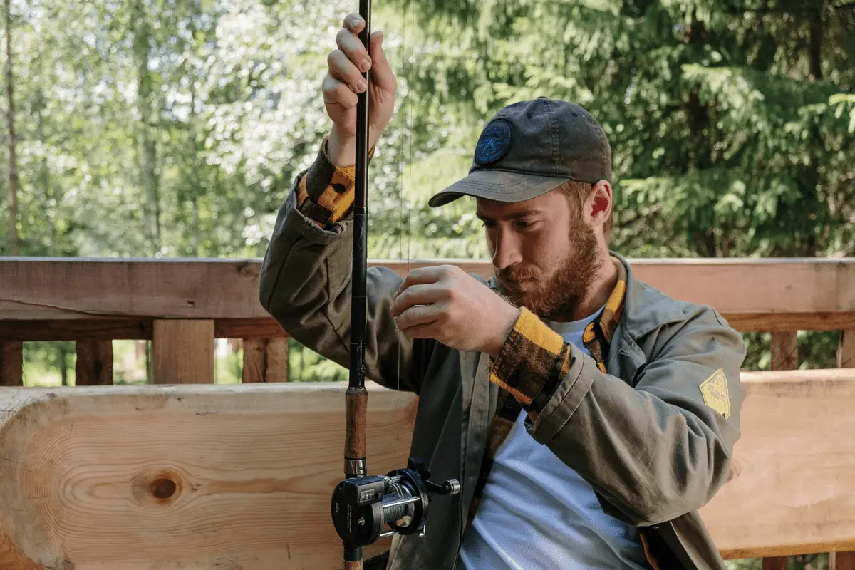 angler putting fishing line on a spinning reel