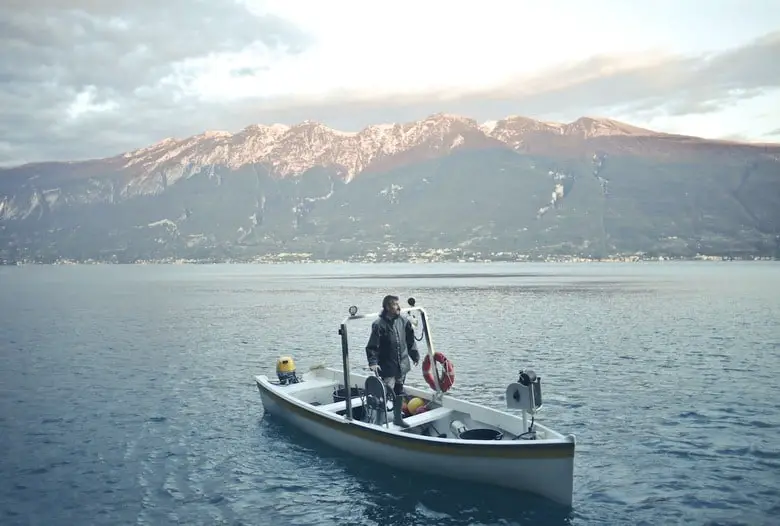 man on a fishing boat in the lake
