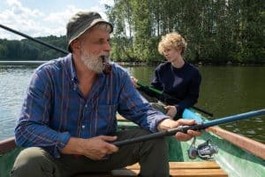 father and son fishing from a boat in the lake