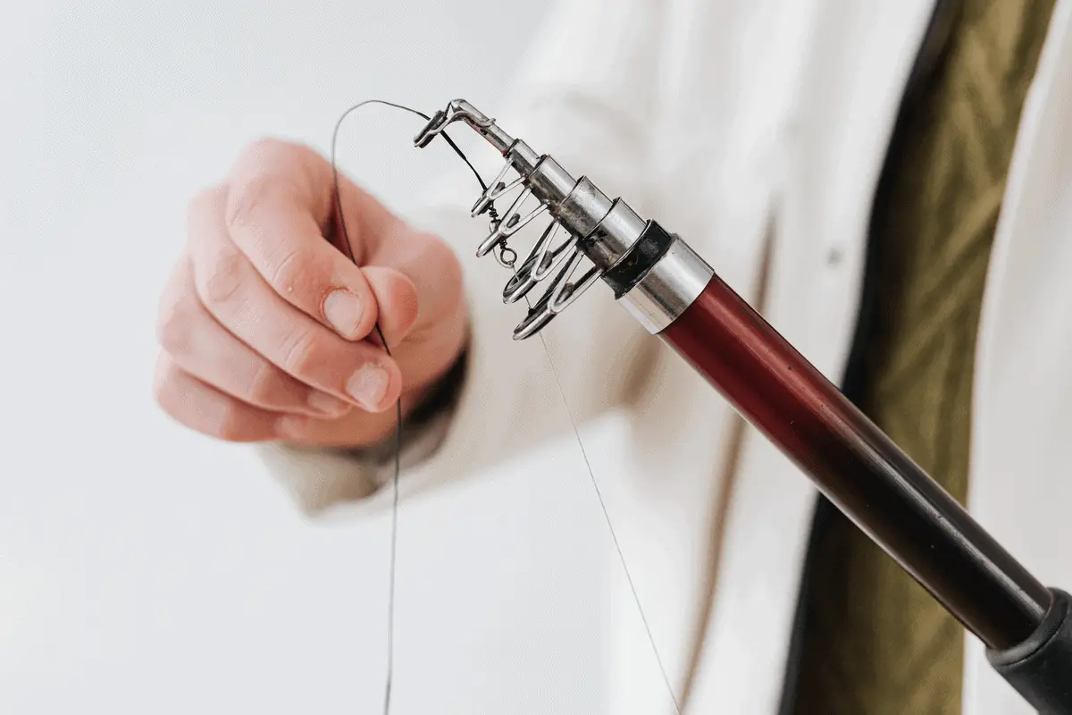 man spooling a fishing line on his reel