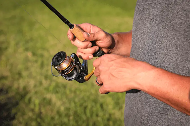 A man holding a fishing rod and reel.